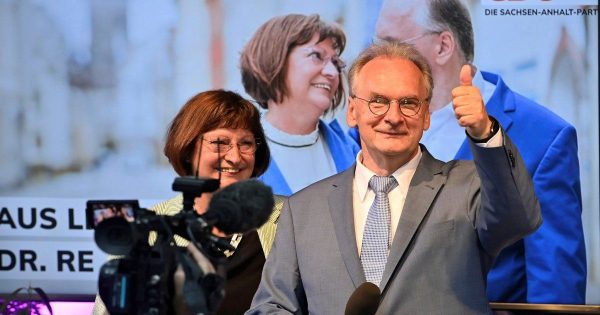 Saxony-Anhalt state governor Reiner Haseloff of Merkel's Christian Democratic Union party, CDU, and his wife Gabriele react, at the CDU election party, after the state election in Magdeburg, Germany, Sunday, June 6, 2021 . The election for the new state parliament in Saxony-Anhalt was the last state election before the federal election in September 2021. (Bernd Von Jutrczenka/dpa via AP)